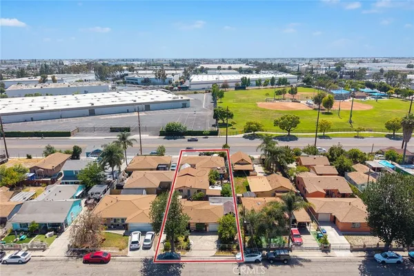 an aerial view of a house with a swimming pool and outdoor seating