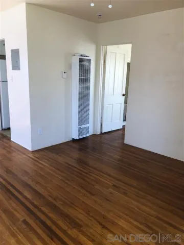 a view of wooden floor and brick walls