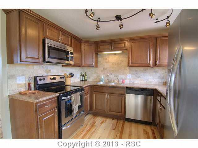 10865 Falling Star Road Fountain, CO 80817 - Photo 5 of 23 Gorgeous remodeled kitchen w/ stainless appliances, hardwood flooring, new counter tops & cabinets.