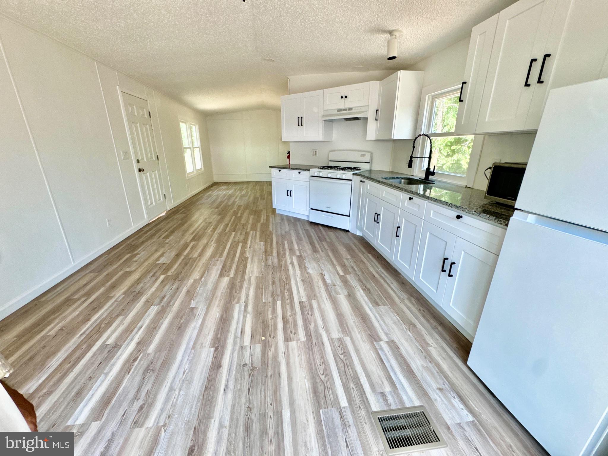 448 Evergreen Road Millville, NJ 08332 - Photo 15 of 25 a kitchen with cabinets a sink and wooden floor