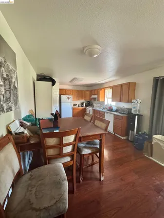 a living room with lots of furniture and a view of kitchen