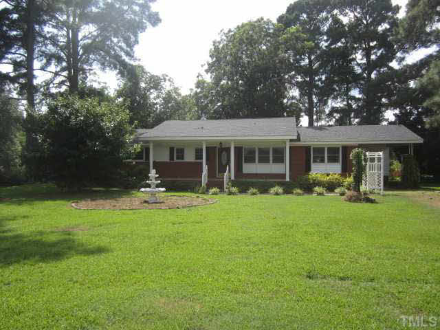 7949 Autry Mill Road Dunn, NC 28334 - Photo 1 of 7 a view of a house with a yard porch and sitting area