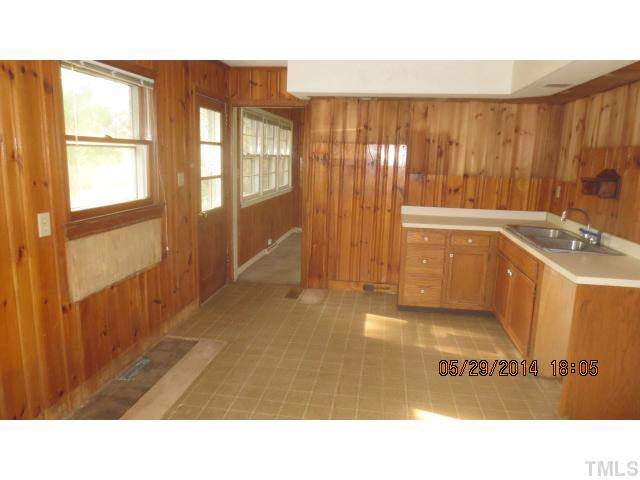 7949 Autry Mill Road Dunn, NC 28334 - Photo 3 of 7 a bathroom with a sink a mirror and a shower