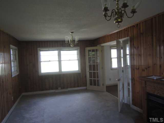 7949 Autry Mill Road Dunn, NC 28334 - Photo 5 of 7 wooden floor in an empty room with a window