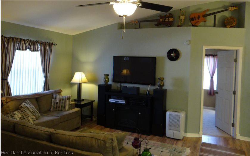 4219 Mandarin Road Sebring, FL 33875 - Photo 13 of 23 a living room with furniture and a flat screen tv