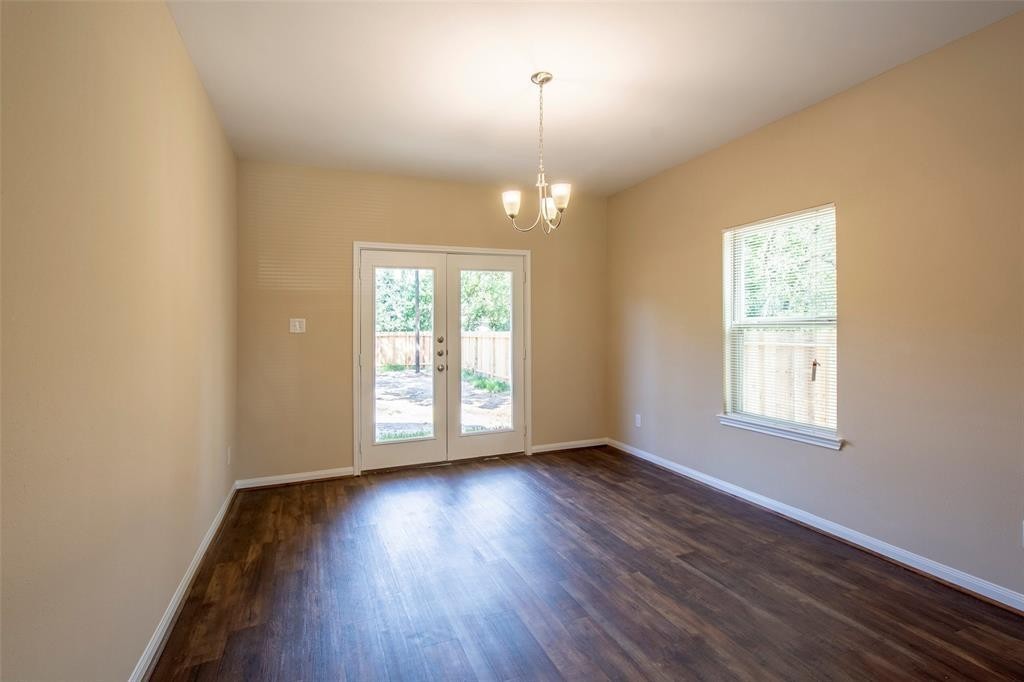 8142 Cabot Street, Unit A Houston, TX 77078 - Photo 18 of 21 an empty room with wooden floor and windows