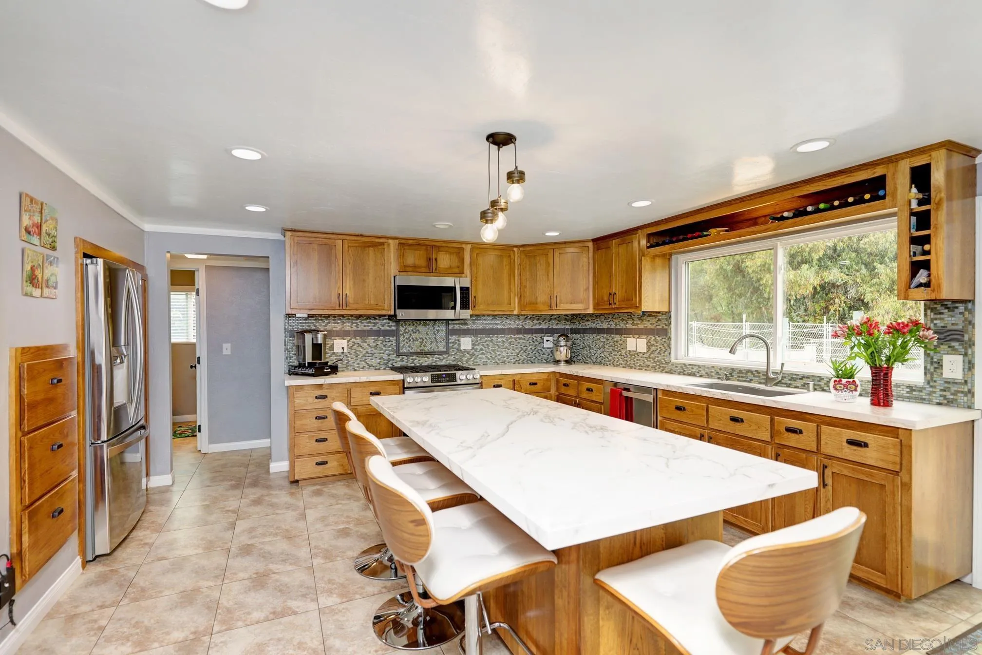15130 Rios Canyon Road El Cajon, CA 92021 - Photo 13 of 59 a large kitchen with stainless steel appliances a stove a refrigerator a oven and a sink