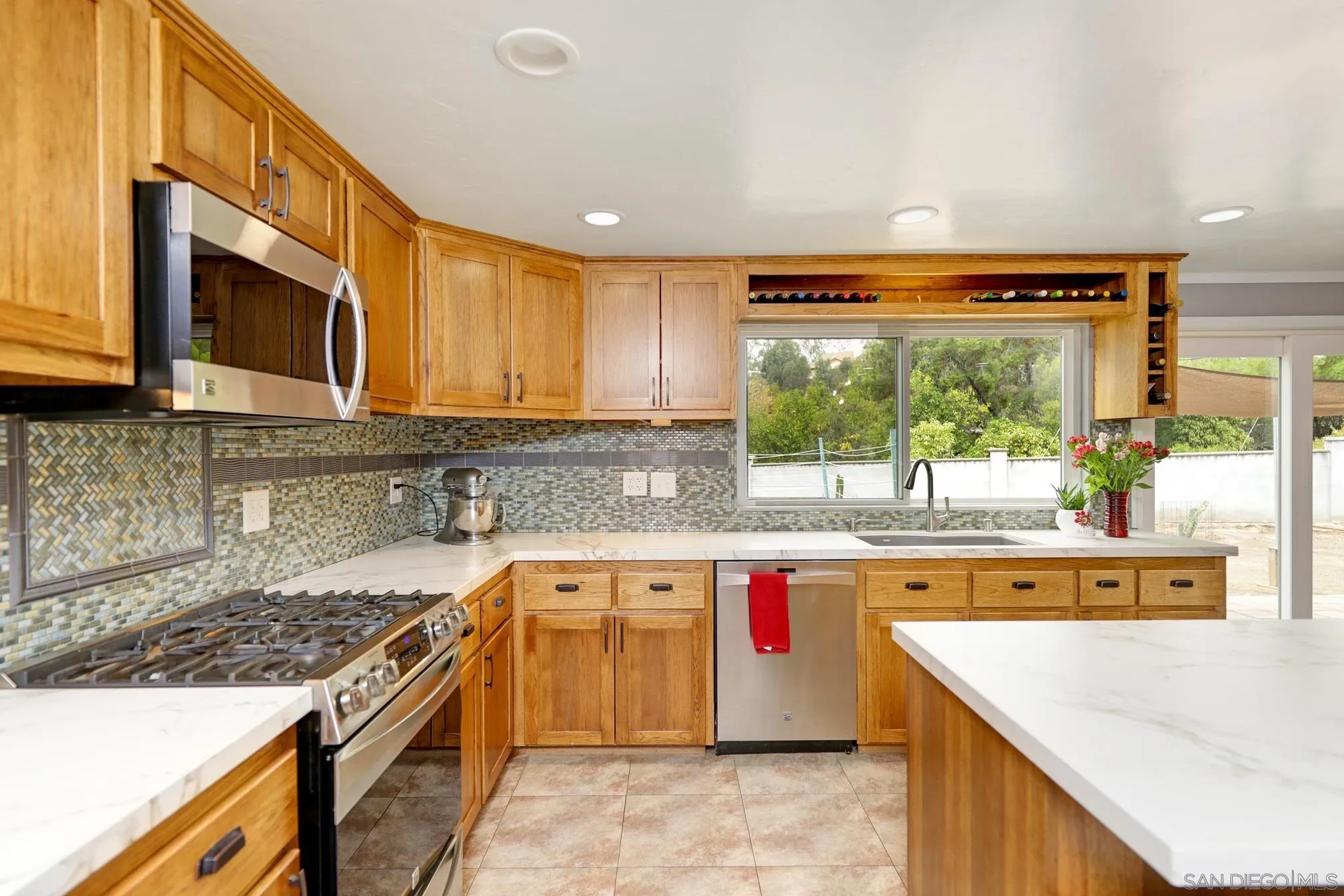 15130 Rios Canyon Road El Cajon, CA 92021 - Photo 15 of 59 a kitchen with stainless steel appliances granite countertop a stove a sink and a microwave