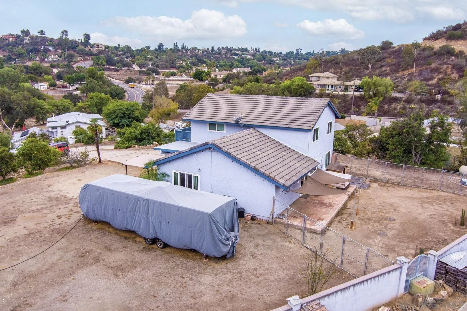 15130 Rios Canyon Road El Cajon, CA 92021 - Photo 42 of 59 an aerial view of a house with a garden and lake view