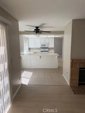 a kitchen with white cabinets stainless steel appliances and sink
