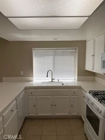 a stove top oven sitting inside of a kitchen