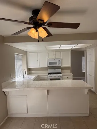 a room with a white cabinets and sink