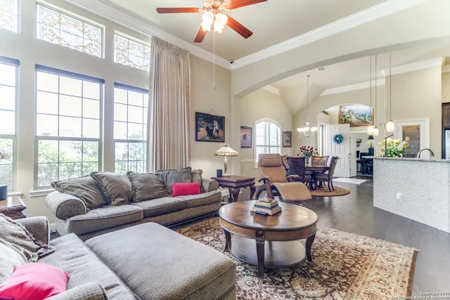 a living room with couches a coffee table and a large window with garden view