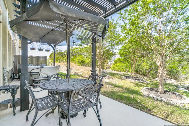 a view of a patio with table and chairs and potted plants