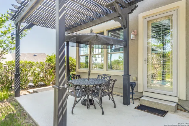 a view of a patio with table and chairs and potted plants