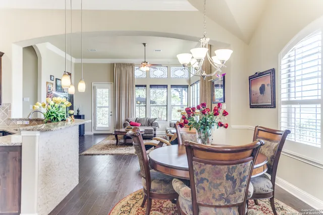 a view of a dining room with furniture and chandelier