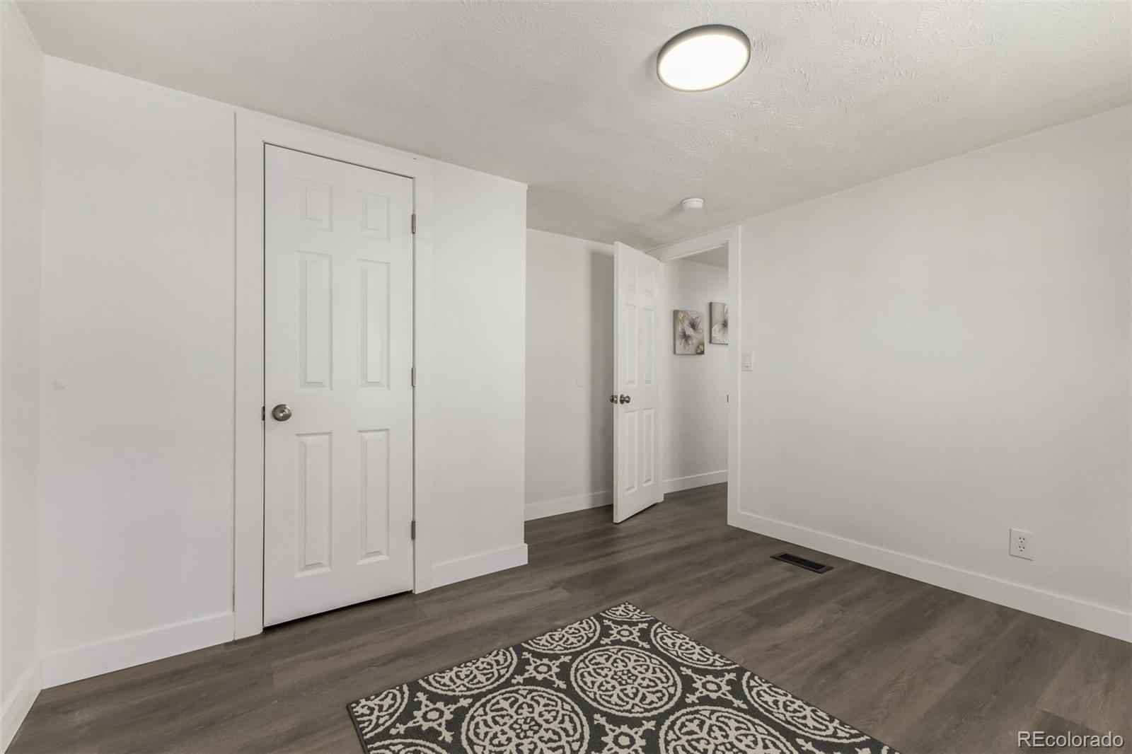 103 North Josephine Avenue Milliken, CO 80543 - Photo 11 of 14 wooden floor in an empty room