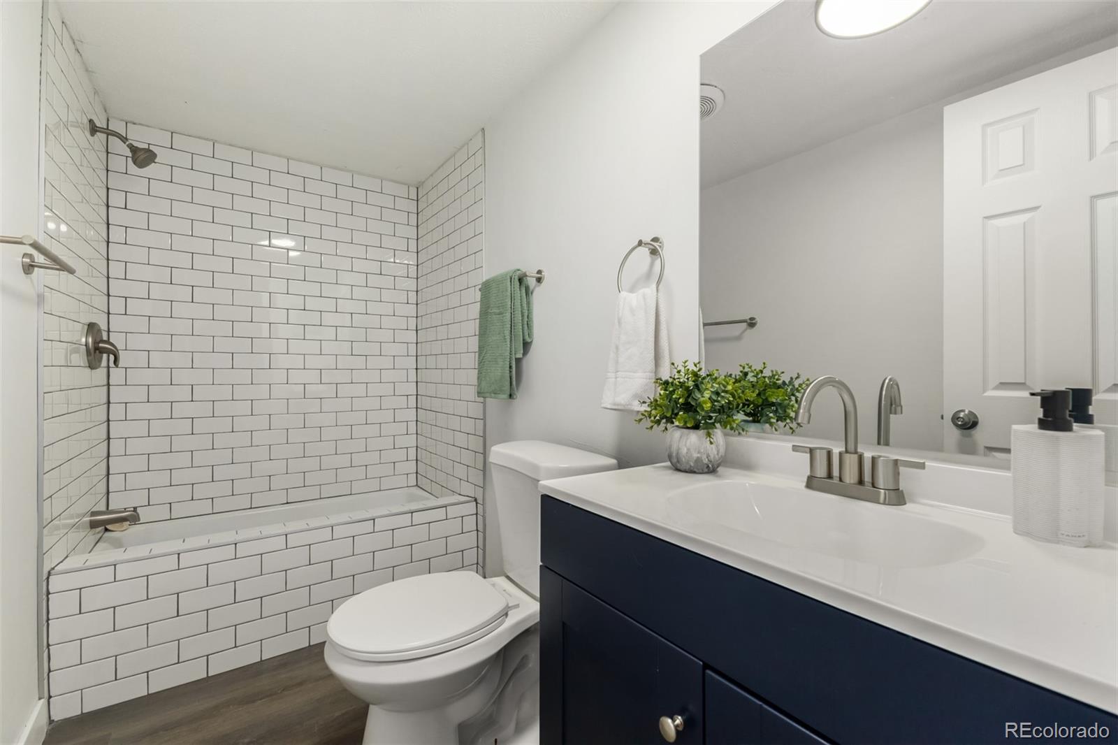 103 North Josephine Avenue Milliken, CO 80543 - Photo 12 of 14 a bathroom with a sink a toilet and shower