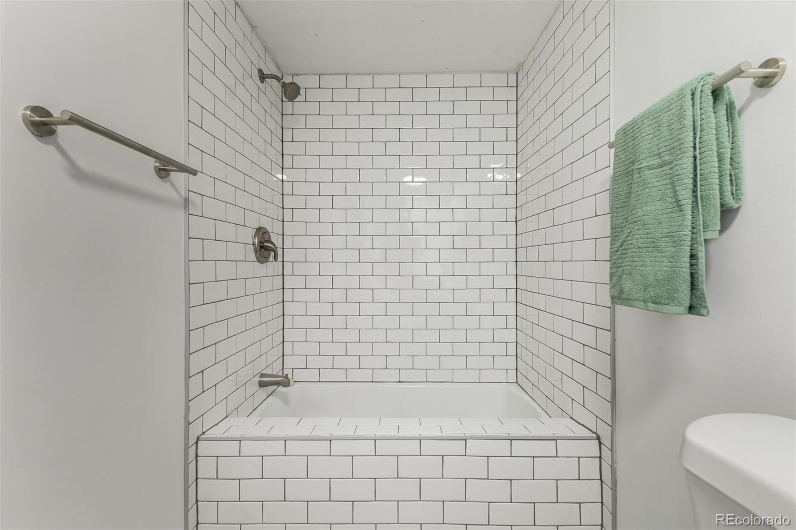 103 North Josephine Avenue Milliken, CO 80543 - Photo 13 of 14 a bathroom with a bathtub and a shower