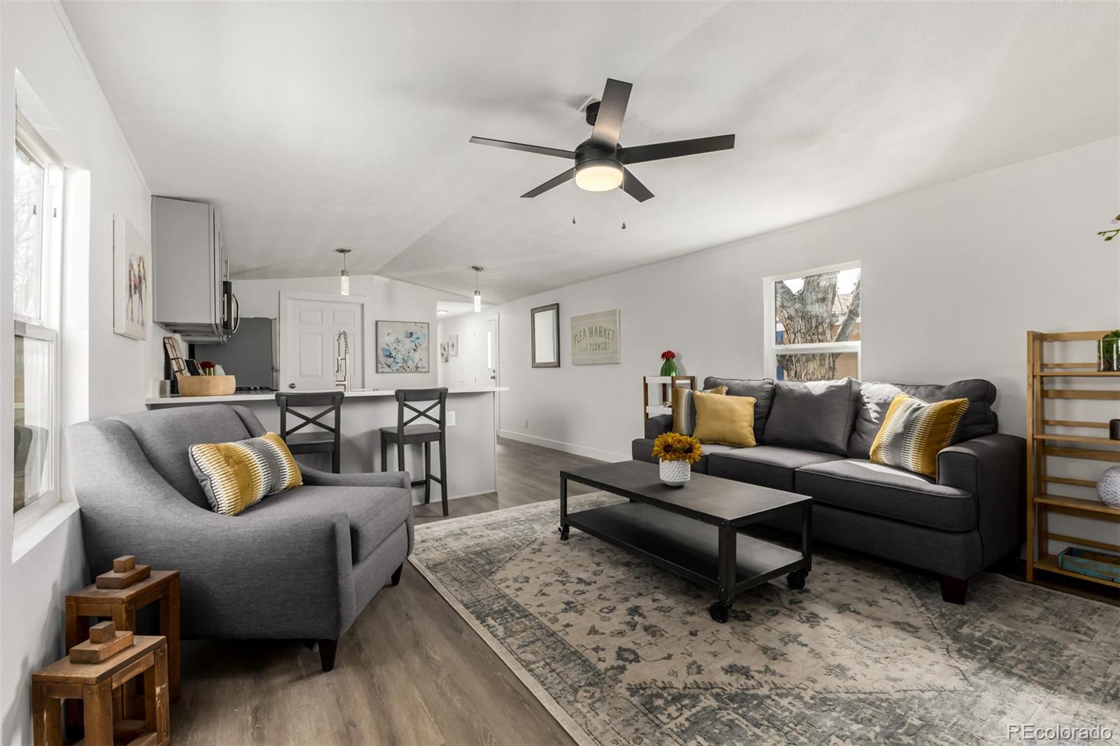 103 North Josephine Avenue Milliken, CO 80543 - Photo 2 of 14 a living room with furniture and a view of kitchen