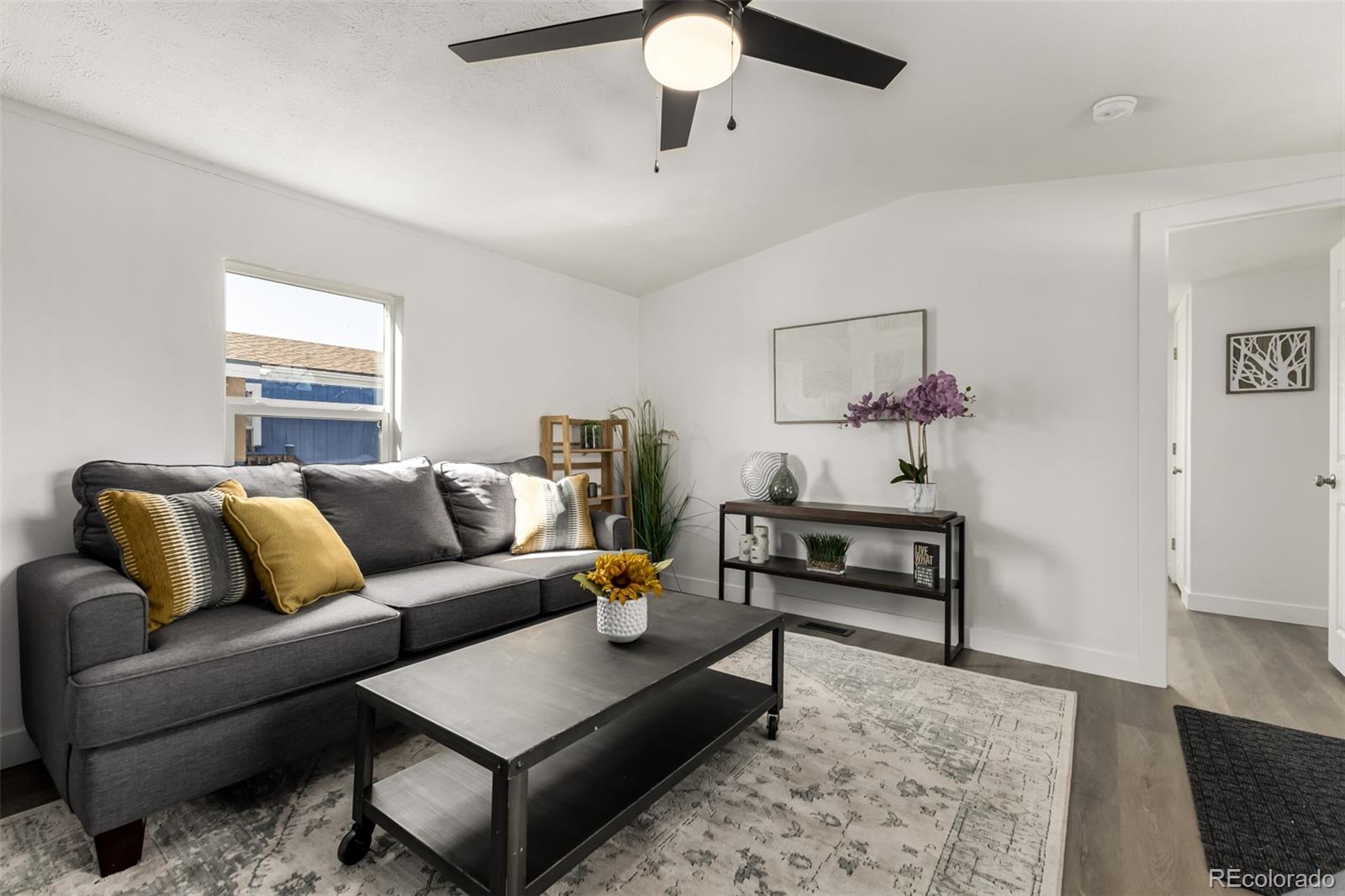 103 North Josephine Avenue Milliken, CO 80543 - Photo 3 of 14 a living room with furniture and a rug