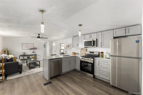 a kitchen with stainless steel appliances and white cabinets