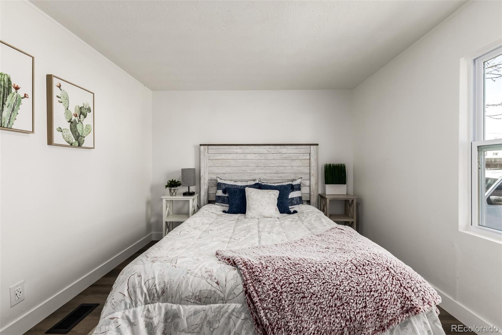 103 North Josephine Avenue Milliken, CO 80543 - Photo 9 of 14 a bedroom with a bed and a window