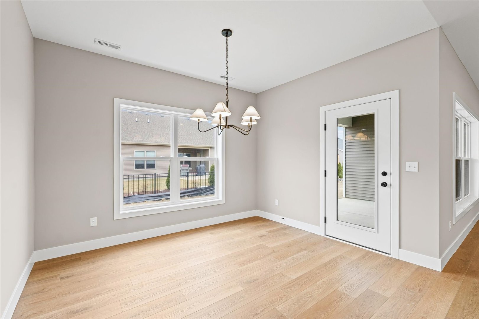 3902 Bay Circle Champaign, IL 61822 - Photo 13 of 29 a view of a room with a chandelier fan and wooden floor