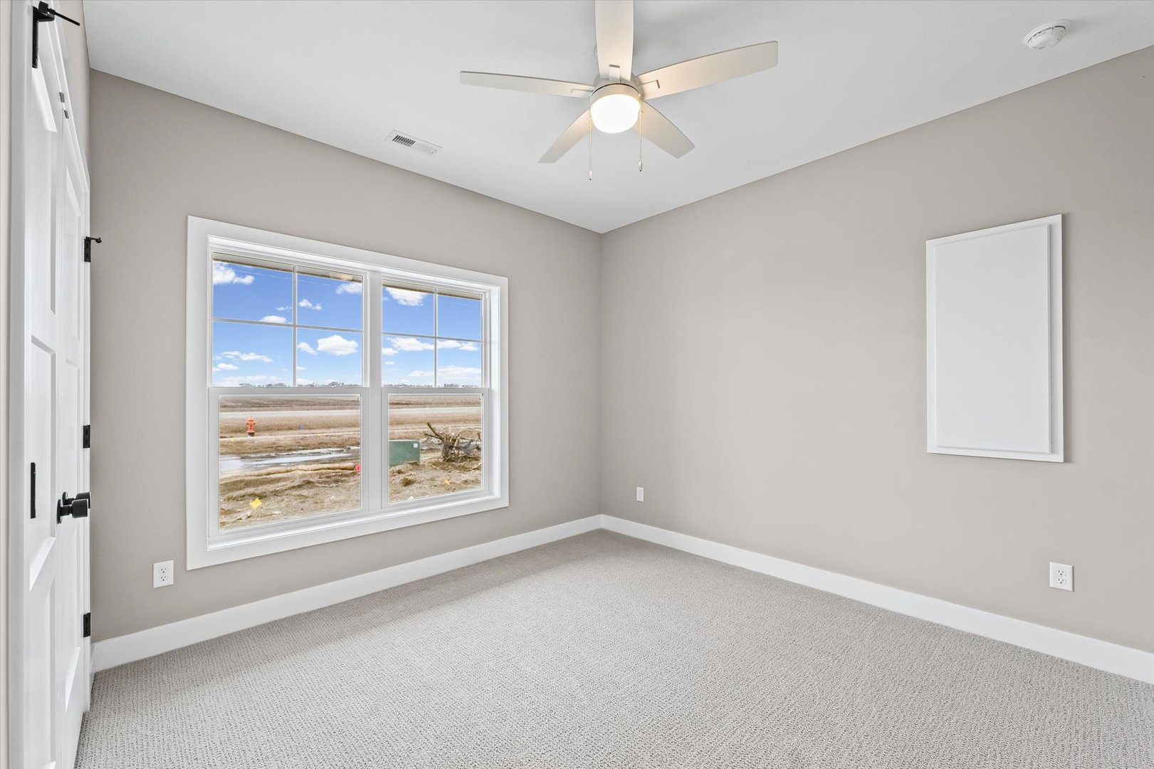 3902 Bay Circle Champaign, IL 61822 - Photo 21 of 29 en empty room with windows and ceiling fan