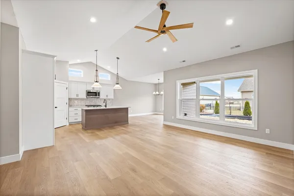 a view of kitchen with stove and cabinets