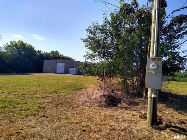 a view of a house with yard swimming pool and sitting area