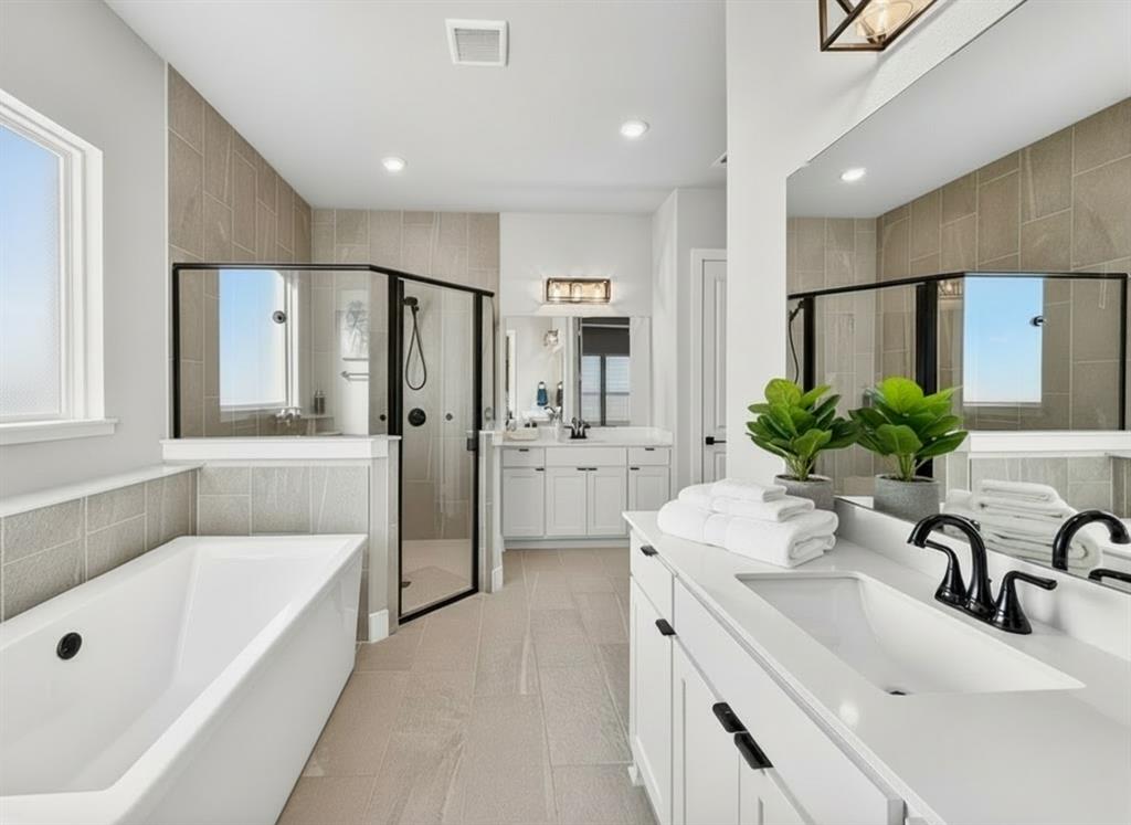 12116 Magma Court Krum, TX 76249 - Photo 15 of 30 a bathroom with a tub sink and mirror