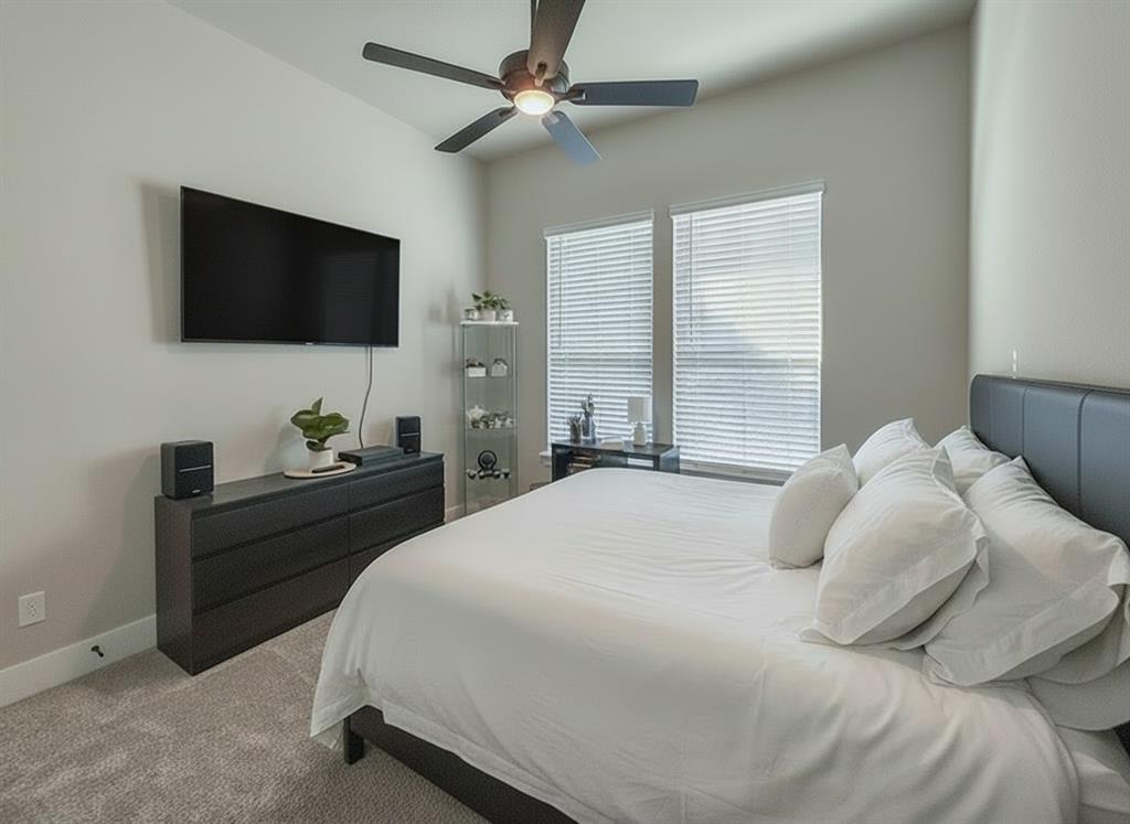 12116 Magma Court Krum, TX 76249 - Photo 18 of 30 a bedroom with a bed and a flat screen tv