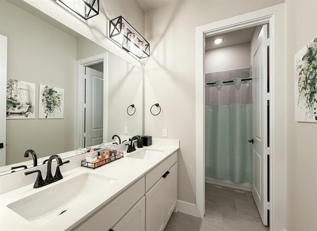 12116 Magma Court Krum, TX 76249 - Photo 19 of 30 a bathroom with a double vanity sink mirror and double