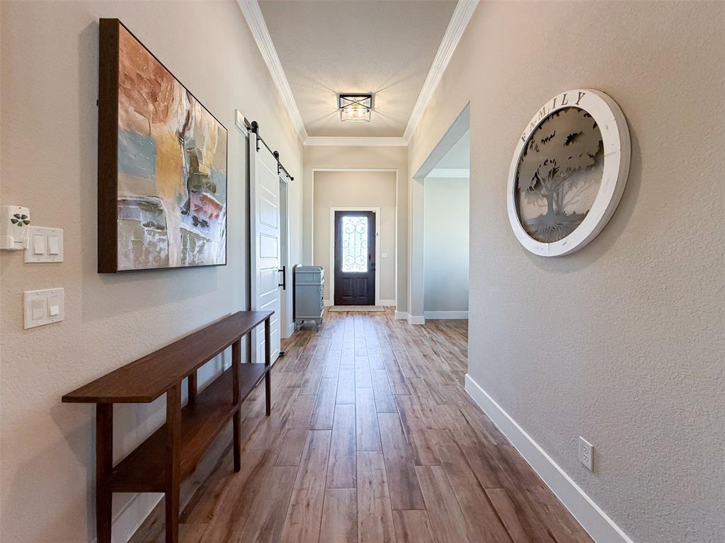 12116 Magma Court Krum, TX 76249 - Photo 5 of 30 a view of a hallway with wooden floor and a hallway