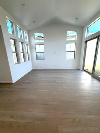 an empty room with windows and entrance