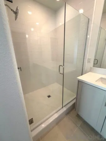 a spacious bathroom with a double vanity sink and mirror