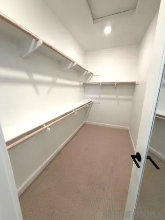 a bathroom with a sink a toilet a mirror and shower