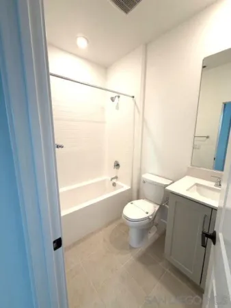 a bathroom with a sink mirror vanity and toilet