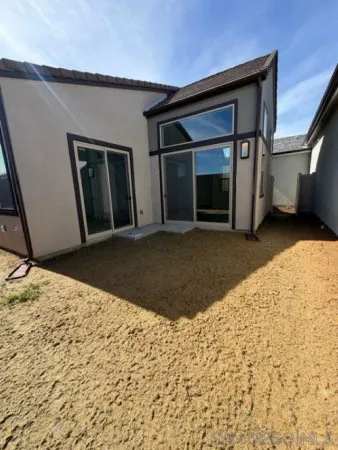a view of house with a big yard and potted plants