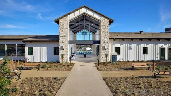 a living room with furniture a flat screen tv and a large window