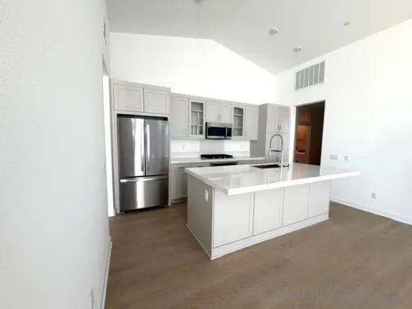 a kitchen with stainless steel appliances a refrigerator and a stove