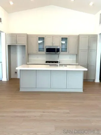 a view of kitchen with cabinets and wooden floor