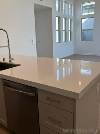 a large kitchen with kitchen island a sink stainless steel appliances and a window