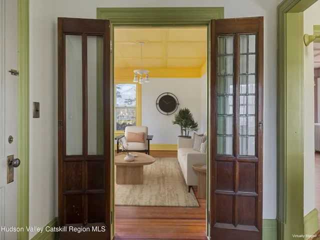 a living room with furniture and a floor to ceiling window