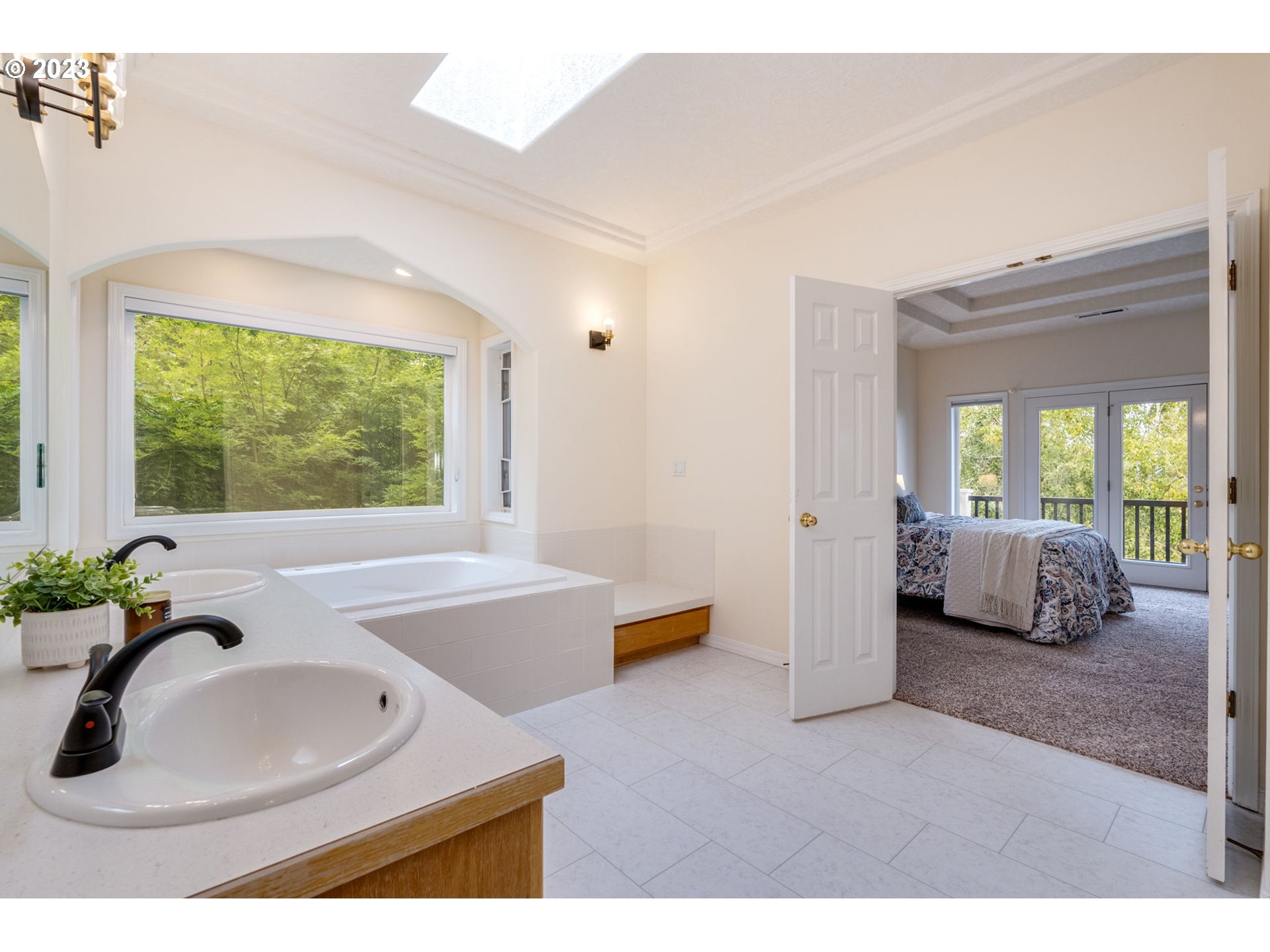 2842 Southeast Morlan Place Gresham, OR 97080 - Photo 19 of 46 a en suite bathroom with a tub double vanity and window