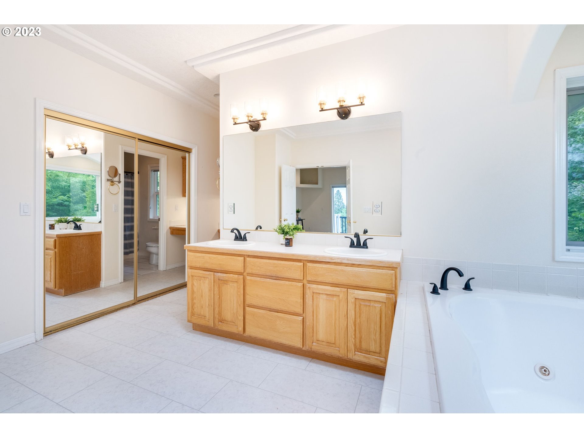 2842 Southeast Morlan Place Gresham, OR 97080 - Photo 21 of 46 a spacious bathroom with a double vanity sink a mirror and shower