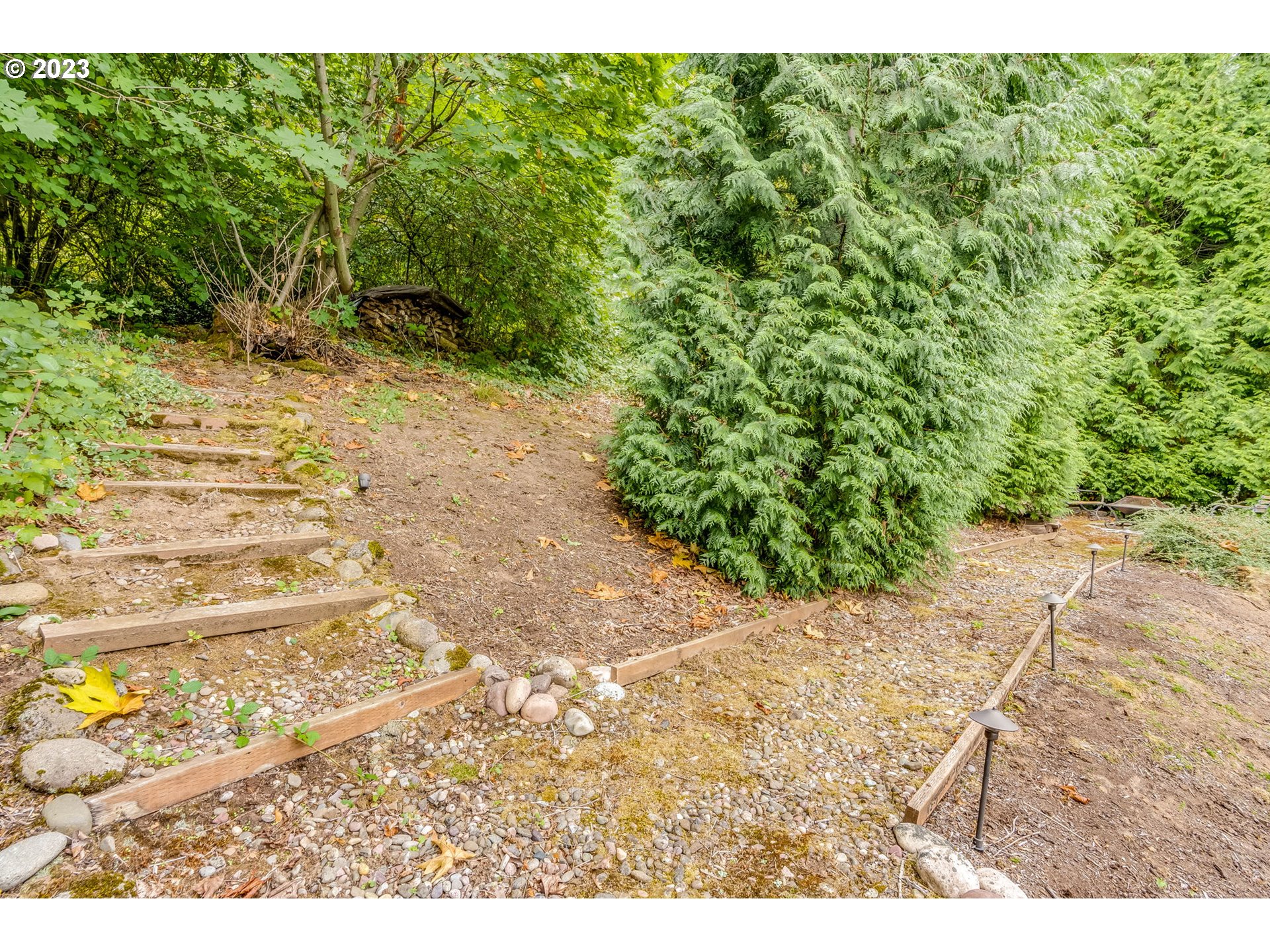 2842 Southeast Morlan Place Gresham, OR 97080 - Photo 41 of 46 a view of a yard with plants and a bench