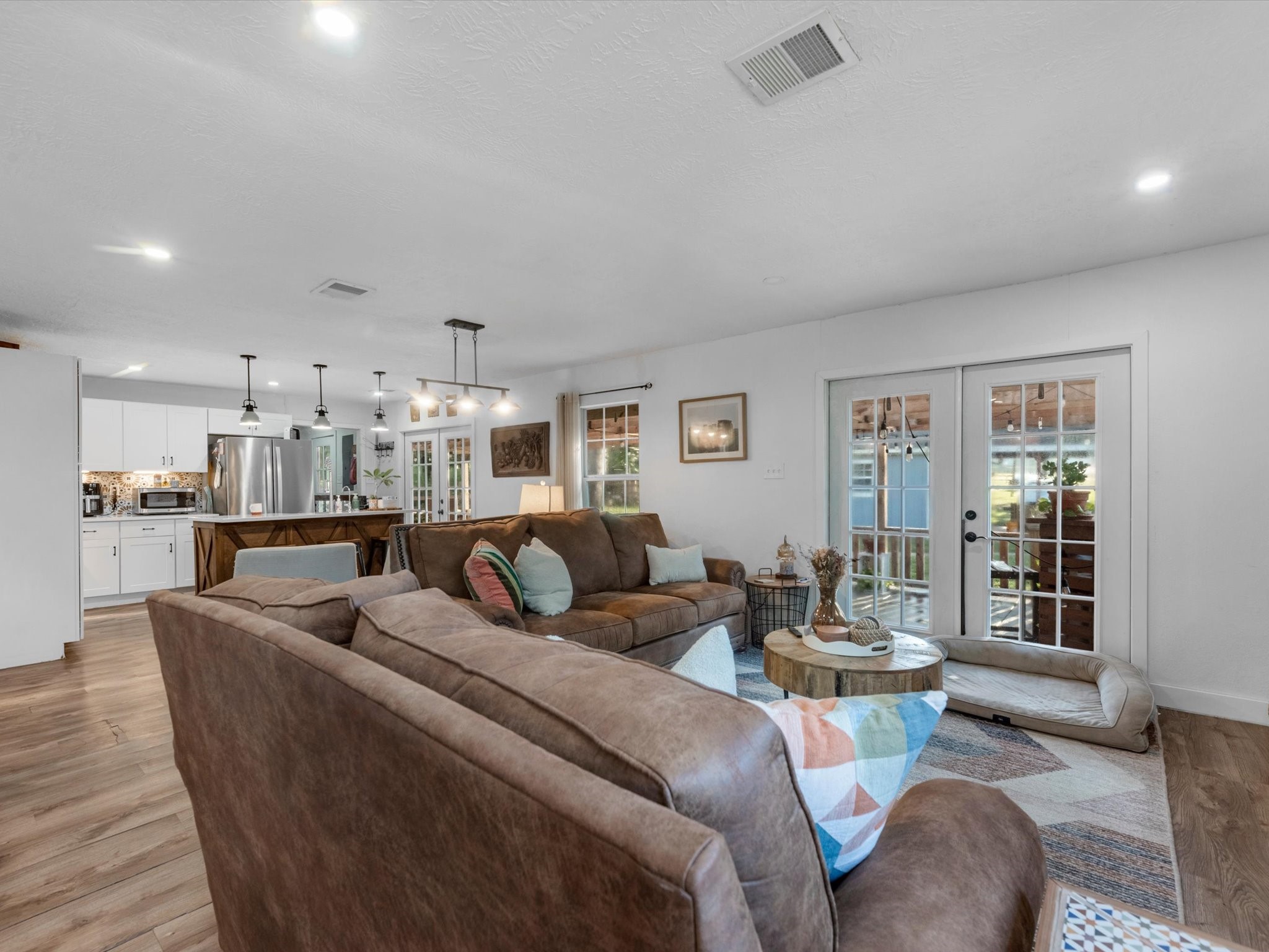 32403 Dobbin-Huffsmith Road Magnolia, TX 77354 - Photo 15 of 31 Open-concept living area flowing seamlessly into the kitchen and dining space, creating a spacious layout ideal for everyday living and entertaining.
