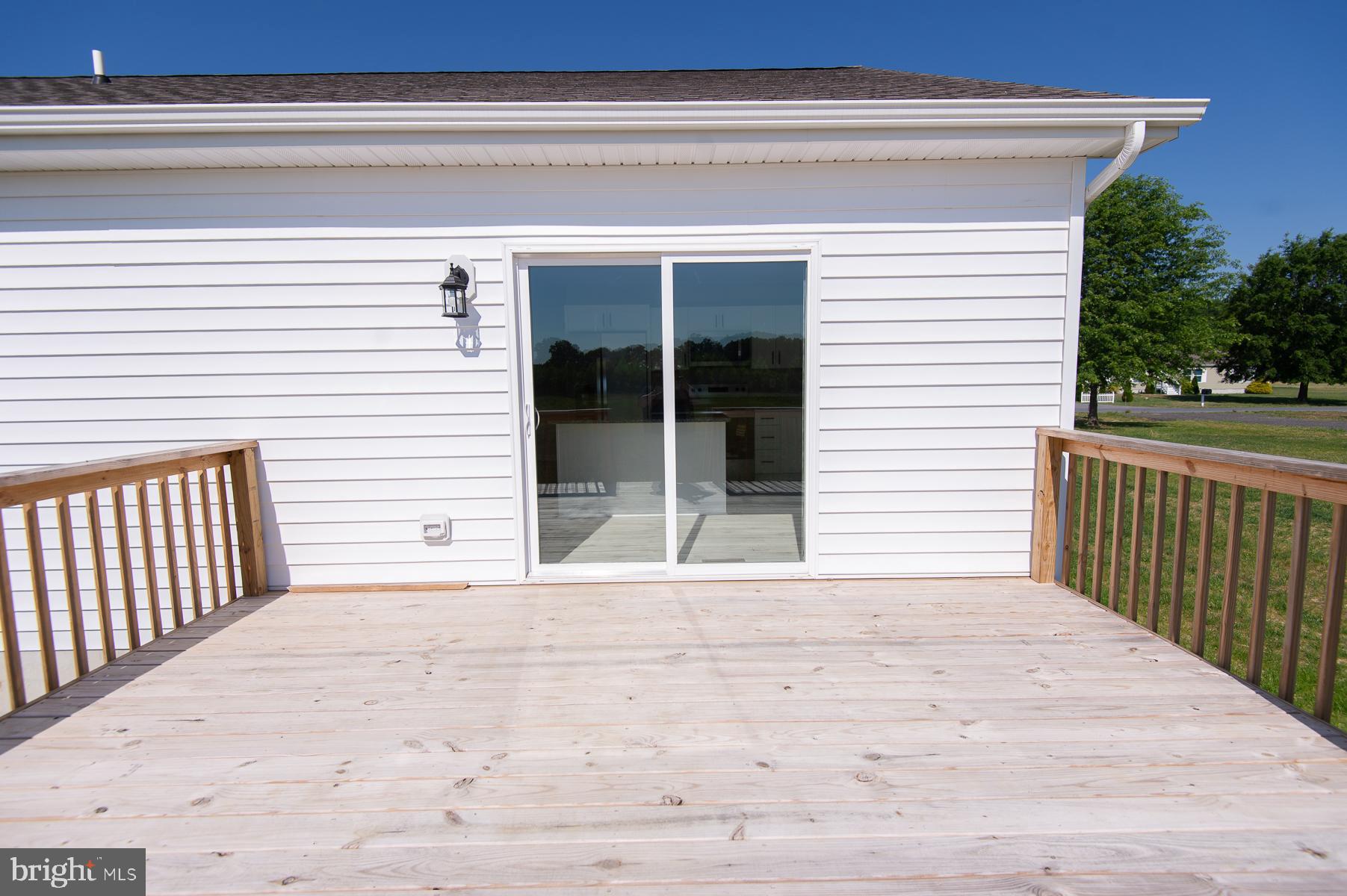 Wrights Rest Road Hurlock, MD 21643 - Photo 18 of 22 a view of a balcony with a floor to ceiling window and yard